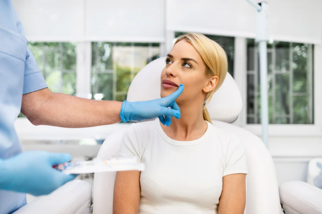 A patient consulting with a professional about a lip filler treatment.