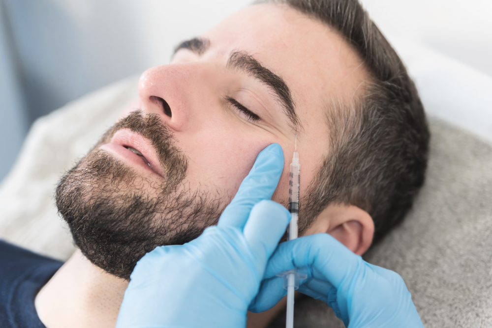 Man receiving Botox injection around eye area.