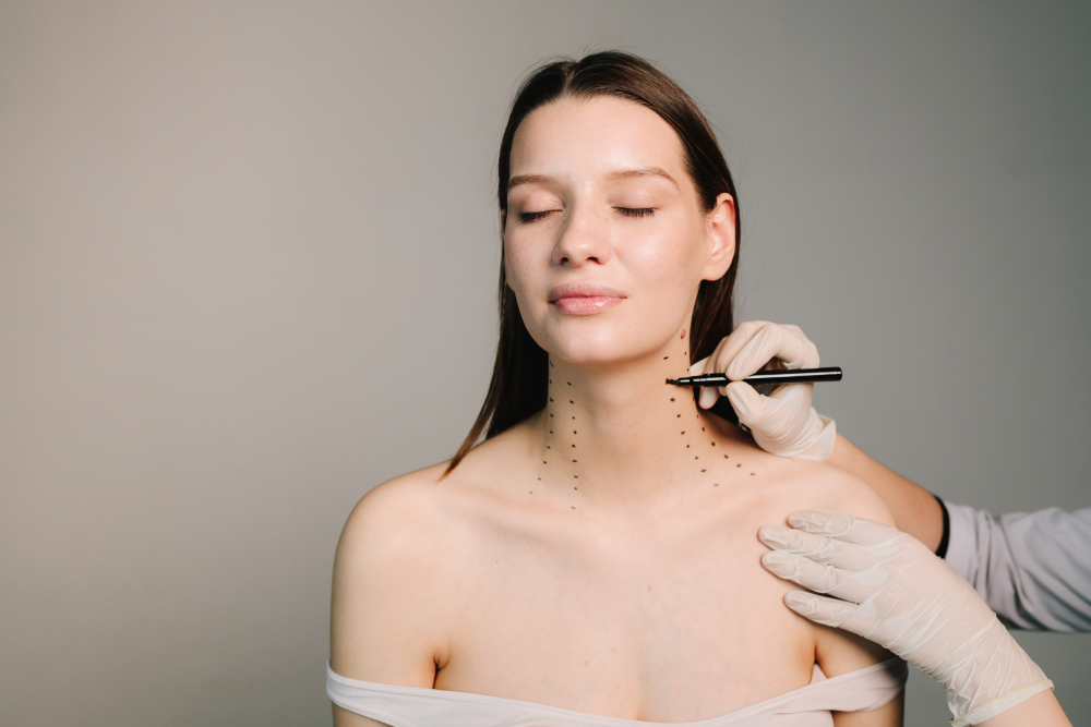 Woman receiving Nefertiti lift markings before Botox treatment.