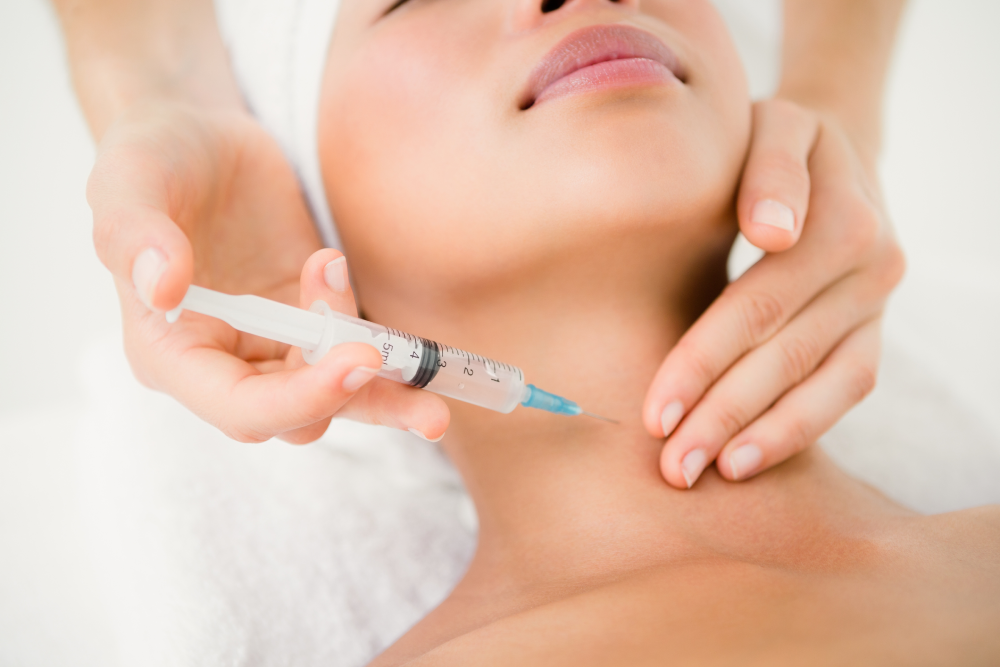 Botox injection being administered to a woman's neck for a Nefertiti lift.